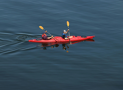 two people in a kayak on the water